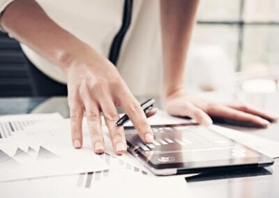 person with a tablet displaying a bar chart
